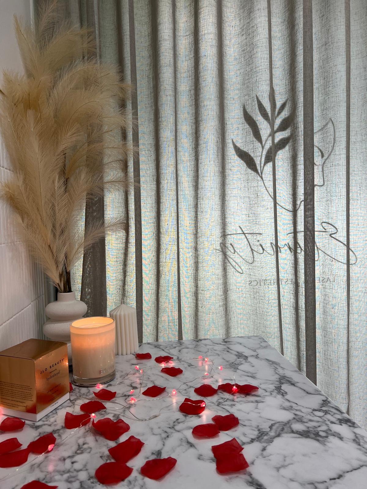 Bridal treatment room at Eternity Laser & Aesthetics Dural — rose petals, candles and luxury atmosphere